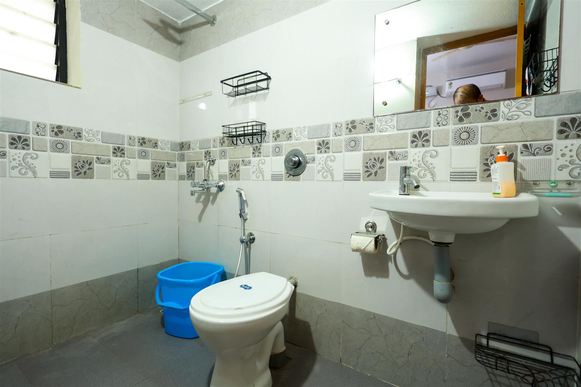Clean western bathroom with floral tiles and modern fittings